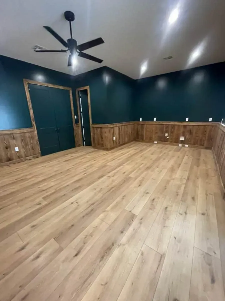 Game room with deep teal walls, wood wainscoting, a ceiling fan, light oak plank floors and double doors