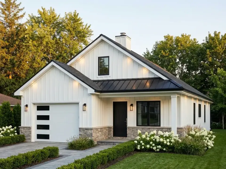 Plan 22103SL facade variant 2 — modern farmhouse with white vertical board-and-batten siding, gray stone water table, dark metal porch roof, black entry door, and white hydrangeas bordering a gray paver drive.