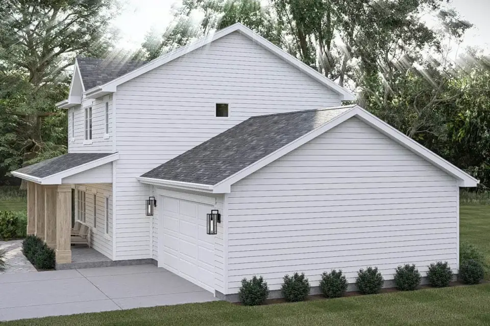 Angled exterior view of the modern farmhouse showing the two-car garage and dark roof against light trim
