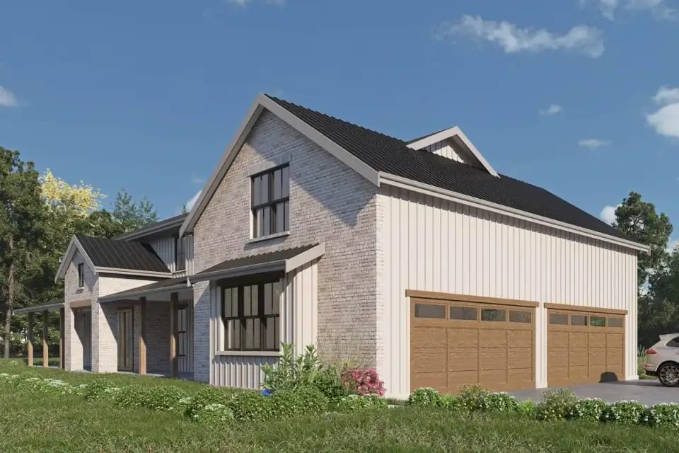 Front elevation of the modern barndominium with mixed vertical siding and stone under a dark standing-seam metal gable roof and square porch columns