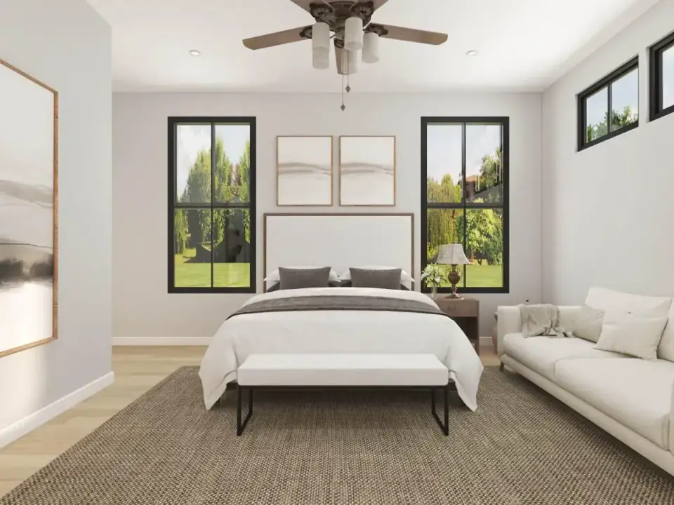 Great room with vaulted ceiling and tall windows flooding the space with light