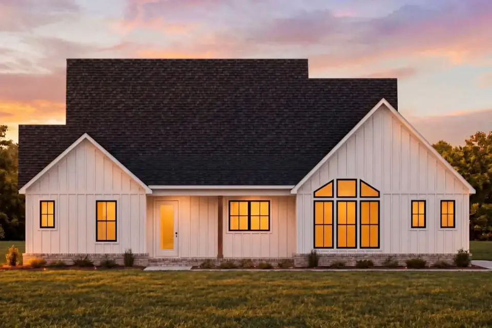 Modern farmhouse exterior with white board-and-batten siding, a wraparound front porch on timber columns, and standing-seam metal roof accents over the porch