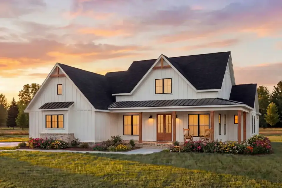 Front elevation of the modern farmhouse showing gabled rooflines, black-framed windows, and the covered wraparound porch