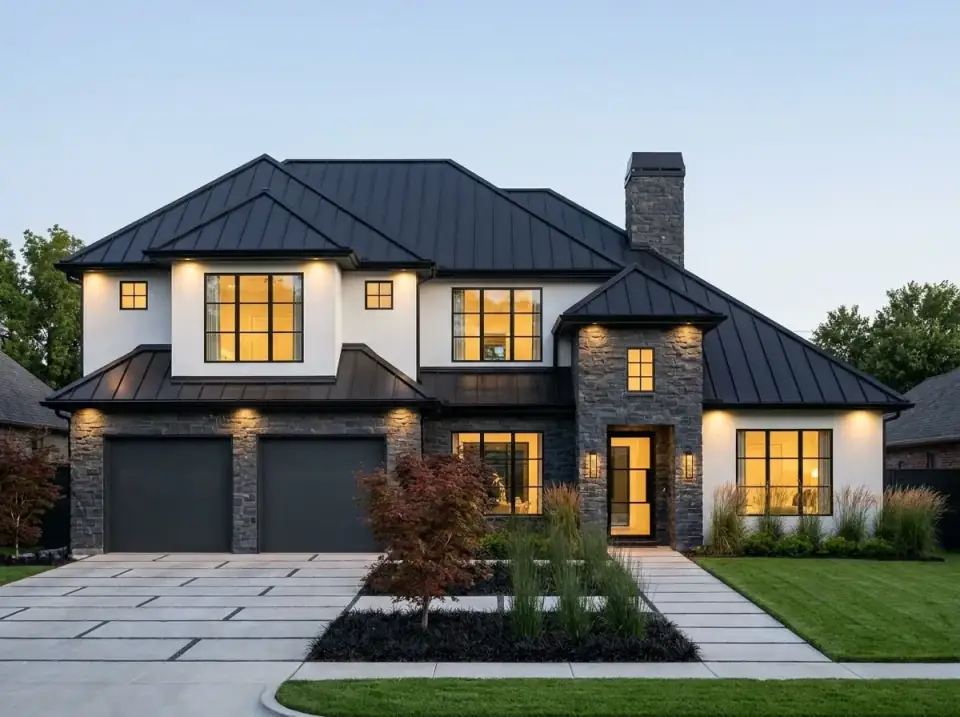 Plan 54062LK as a high-contrast modern home with stark white stucco against dark grey stone veneer on the gables, black window frames, a black metal roof, a Japanese maple focal point, and concrete pavers with grass joints